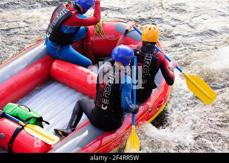 People taking part in a team building white water rafting event on the River Dee in Llangollen North Wales Stock Photo