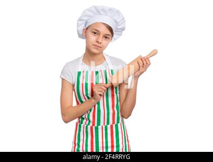 Girl in a chef's hat with emotions holding a rolling pin isolated on a white background. Stock Photo