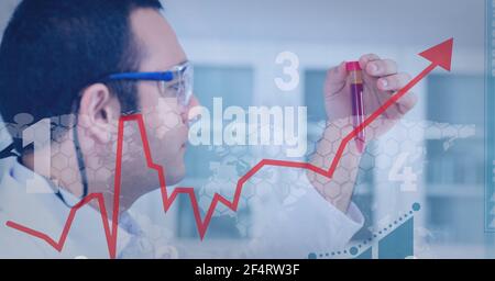 Financial data processing against male caucasian health worker working at laboratory Stock Photo