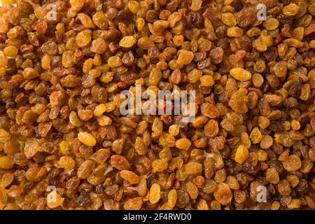 Background of raisins. Dried fruits of close up. Top view. Background raisins Kishmish. Dried fruit in the sun. Stock Photo