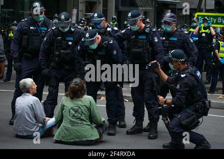 Melbourne, Australia. 23rd March 2021. Extinction Rebellion protesters refusing to move are about to be taken away by police.  Disruptions continue in the Melbourne CBD for the second day in a row as they attempt to raise public awareness on the issue of climate change inaction. Credit: Jay Kogler/Alamy Live News Stock Photo