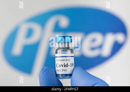 Doctor hand in latex blue gloves holds Covid-19 coronavirus vaccine vial. Stock Photo