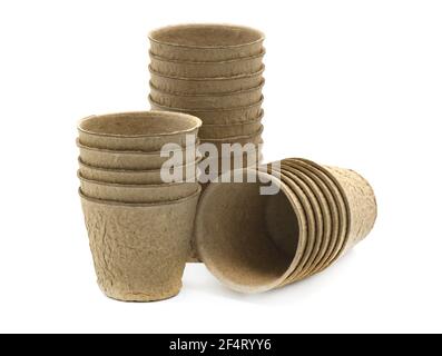 group of round fibre pots used as a biodegradable method or planting seeds in a garden greenhouse or allotment  shot on a white background Stock Photo