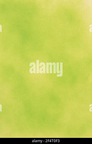 green spray paint on a gray colored paper background Stock Photo