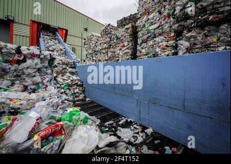 Plastic waste on a conveyor belt for sorting at a materials recycling facility in the UK. Stock Photo