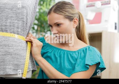 woman working on tailors dummy Stock Photo