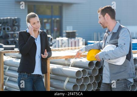 construction manager and worker checking pipes quality Stock Photo