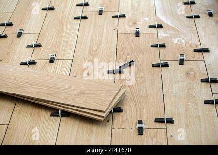 Tiling spacers fitted to tiles laid in a new conservatory floor Stock Photo