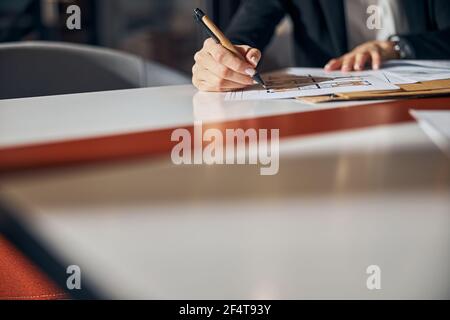 Engineer making corrections to a floor plan with a ball-point pen Stock Photo