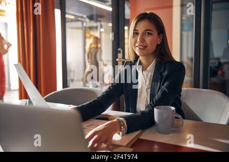 Joyous lady engineer posing for the camera in the workplace Stock Photo