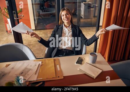 Female architect with technical drawings posing for the camera Stock Photo