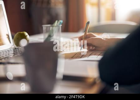 Experienced draftswoman modifying a building plan with a ball-point pen Stock Photo