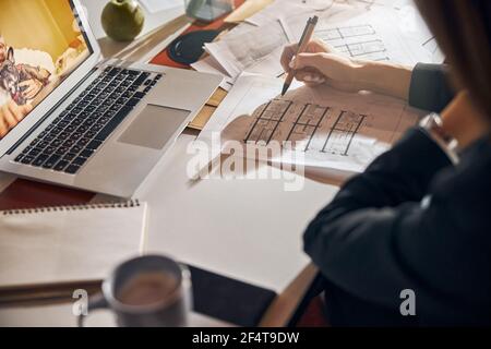 Architect making corrections to a house plan with a ball-point pen Stock Photo