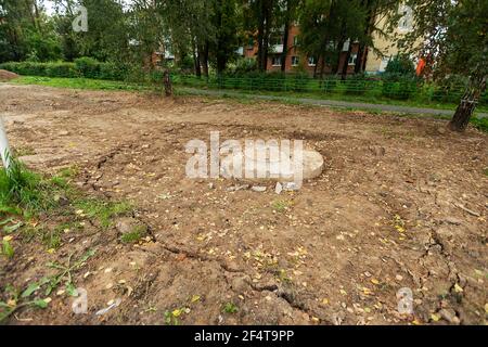 poorly executed road repairs. replacing the old curb stone with a new one Stock Photo