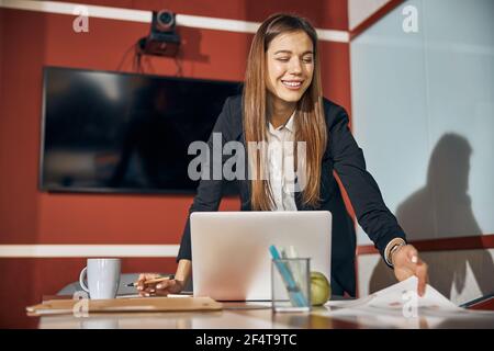 High-spirited lady engineer looking at technical drawings on the desk Stock Photo