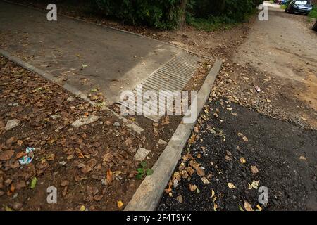 poorly executed road repairs. replacing the old curb stone with a new one Stock Photo