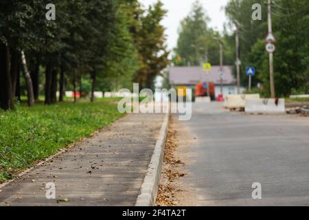 poorly executed road repairs. replacing the old curb stone with a new one Stock Photo