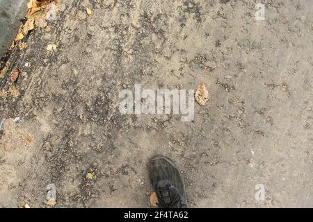 poorly executed road repairs. replacing the old curb stone with a new one Stock Photo