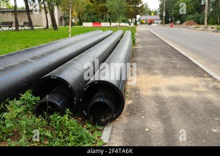 poorly executed road repairs. replacing the old curb stone with a new one Stock Photo