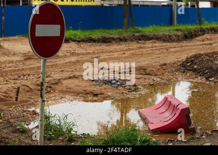 poorly executed road repairs. replacing the old curb stone with a new one Stock Photo