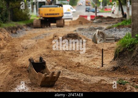 poorly executed road repairs. replacing the old curb stone with a new one Stock Photo