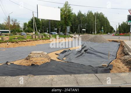 poorly executed road repairs. replacing the old curb stone with a new one Stock Photo