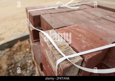 poorly executed road repairs. replacing the old curb stone with a new one Stock Photo