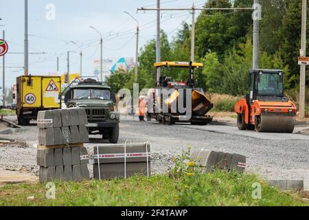 poorly executed road repairs. replacing the old curb stone with a new one Stock Photo