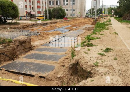 poorly executed road repairs. replacing the old curb stone with a new one Stock Photo