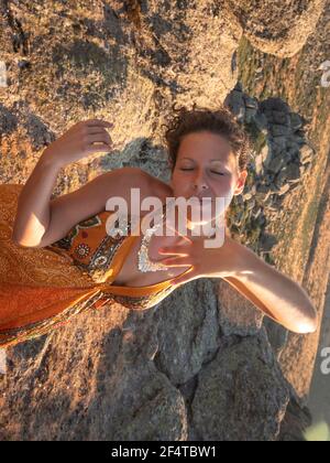Vertical view of woman dancing for her self in the sunset. Stock Photo