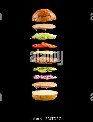 Floating burger ingredients on the black background Stock Photo