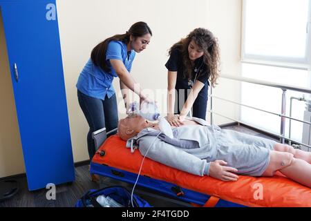 Nursing students are learning how to rescue the patients in emergency. CPR training with CPR doll. Stock Photo