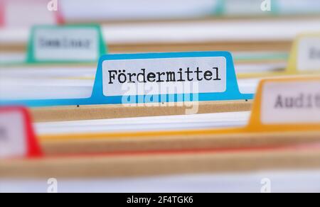 File folders with a tab labeled Funding in german - Fördermittel Stock Photo