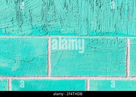 Aquamarine or azure paint on the wall of brick blocks with cracked texture background. Stock Photo
