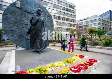 Lonon, UK. 23rd Mar, 2021. Those who have suffered from coronavirus remembered on one year lockdown anniversary with one minute silence at St Thomas hospital opposite the Houses of Parliament. Held at the statue of Mary Seacole on Westminster Bridge. 126000 people have so far died from the virus.  Credit: JOHNNY ARMSTEAD/Alamy Live News Stock Photo