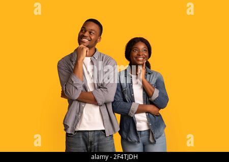 Dreamy young african american couple thinking about something and looking away Stock Photo