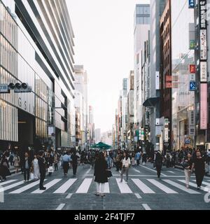 Ginza, Tokyo, Japan - The central Chuo Dori street is closed to automobile traffic and become a large pedestrian zone on the weekend. Stock Photo