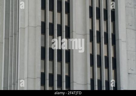 Exterior close up of generic office building skyscraper tower in downtown city area of black windows and concrete construction Stock Photo