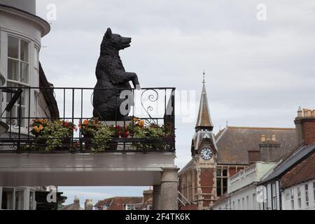 A statue of a large bear looks out along South Street from a hotel balcony in Wareham, Dorset in the UK, taken on the 23rd July 2020 Stock Photo