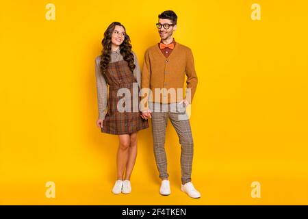 Full length body size view of attractive glad cheerful couple holding hand romance isolated on bright yellow color background Stock Photo