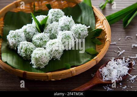 onde-onde made from glutinous rice flour and filled with brownn sugar covered with grated coconut. Stock Photo