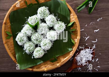 onde-onde made from glutinous rice flour and filled with brownn sugar covered with grated coconut. Stock Photo