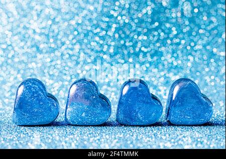 Glass blue hearts on a blue background. Concepts of valentines day card, wedding and invitation. Place for your text. Stock Photo