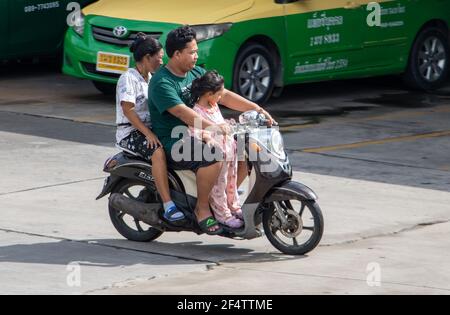 SAMUT PRAKAN, THAILAND, JUNE 26 2020, The family rides together on one motorcycle Stock Photo