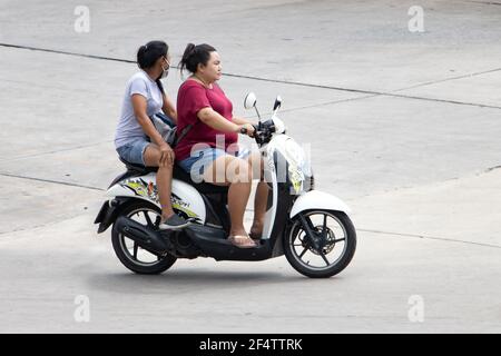 SAMUT PRAKAN, THAILAND, JUNE 26 2020, Two women rides on motorcycle at the street. Stock Photo