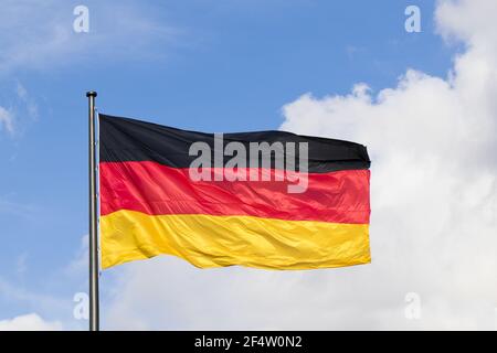 German flag on blue sky background Stock Photo