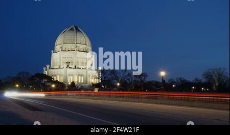 Baha'i House of Worship in Wilmette, Illinois at night. Light trails from passing cars in the foreground. Stock Photo