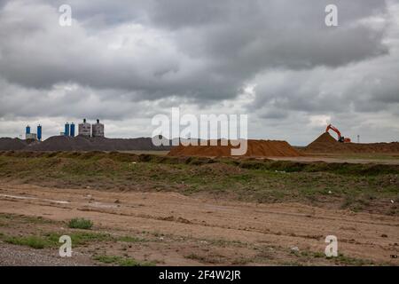 Asphalt mixing plant after the rain on cloudy grey sky background. Panorama view. Stock Photo