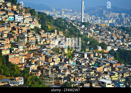 Landscape with panoramic view of the favela Rocinha and the Maracanã Stadium on the background in Rio de Janeiro, Brazil. Stock Photo
