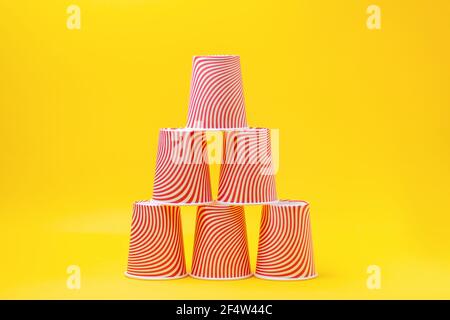 Pyramid of red paper cups on green background. minimalism concept Stock  Photo - Alamy